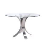 Dining table with curved polished steel base