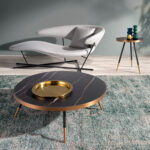 Round corner table in black porcelain marble and steel with a bronze-colored chrome bath.