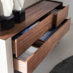 Chest of drawers in walnut wood and chrome-plated steel and recycled leather