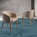 Chair upholstered in fabric with Walnut colored wooden legs