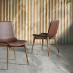 Chair upholstered in leatherette with solid wood legs in Walnut color