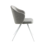 Chair upholstered in fabric with white steel legs