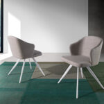 Chair upholstered in fabric with white steel legs