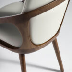 Chair upholstered in leatherette with Walnut colored wooden structure