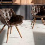 Chair upholstered in leatherette with solid wood legs in Walnut color