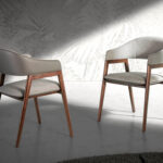 Chair upholstered in fabric and leatherette with Walnut colored wooden frame