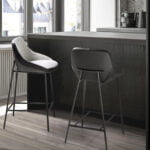 Stool upholstered in fabric and leatherette with black steel legs