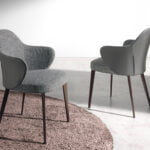 Chair upholstered in fabric and eco-leather with darkened bronze steel structure