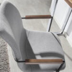 Swivel chair upholstered in fabric with black steel legs