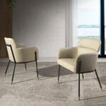 Chair upholstered in eco-leather with black and gold steel structure