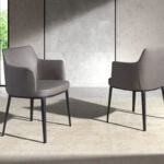 Dining chair upholstered in fabric and black steel structure.