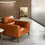 Armchair upholstered in leather and Walnut wood legs