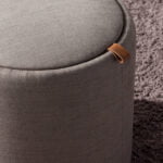 Puff upholstered in gray fabric