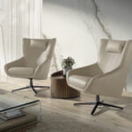 Swivel armchair with cushion upholstered in leather