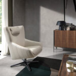 Swivel armchair with cushion upholstered in leather
