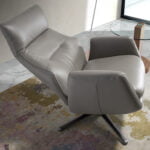 Leather upholstered reclining swivel armchair with darkened steel legs