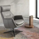 Leather upholstered reclining swivel armchair with darkened steel legs