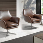 Swivel armchair upholstered in leather and polished steel structure.