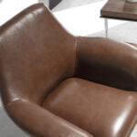 Swivel armchair upholstered in leather and polished steel structure.