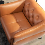 Leather upholstered capitonné armchair