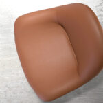 Brown leatherette swivel armchair