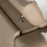 Corner sofa upholstered in leather with relax mechanism