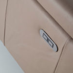 Corner sofa upholstered in leather with relax mechanism