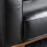 Armchair upholstered in leather and Walnut wood legs