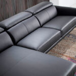 Chaise longue sofa upholstered in leather and black steel legs