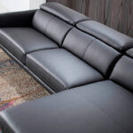 Chaise longue sofa upholstered in leather and black steel legs