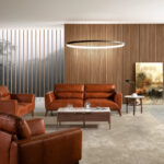 2-seater sofa upholstered in leather with Walnut wood legs
