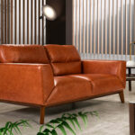 2-seater sofa upholstered in leather with Walnut wood legs