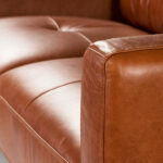 2-seater sofa upholstered in leather with Walnut wood legs