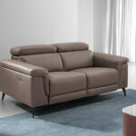2 seater sofa upholstered in mink coloured cow leather and black steel legs.
