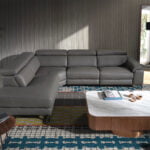 Leather upholstered corner sofa with relaxation mechanism