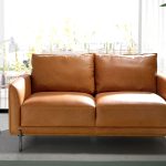 2 seater sofa upholstered in leather with darkened steel legs