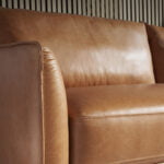 2 seater sofa upholstered in leather with darkened steel legs