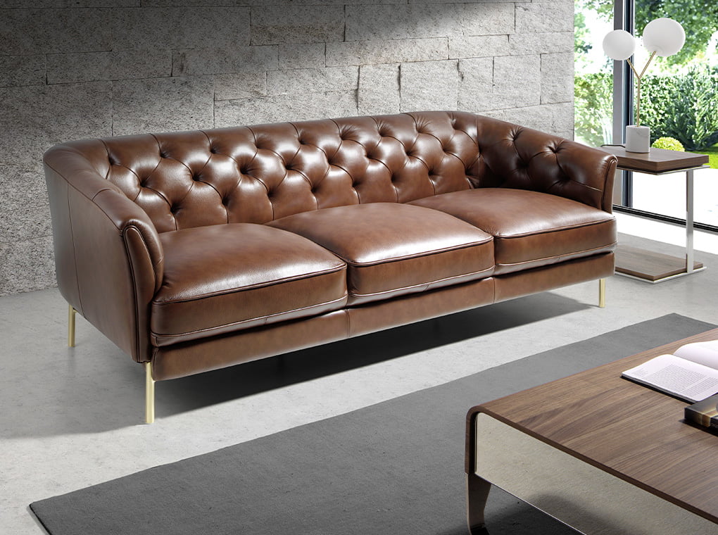 3 seater sofa upholstered in leather with golden polished steel legs