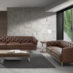 3 seater sofa upholstered in leather with golden polished steel legs
