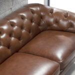 3 seater sofa upholstered in leather with golden polished steel legs