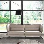 3 seater sofa upholstered in leather and decorative cushions