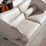 3 seater sofa upholstered in leather and decorative cushions