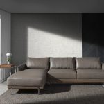 Chaise longue sofa upholstered in leather and legs in darkened steel.