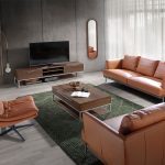 2 seater sofa upholstered in leather with darkened steel legs