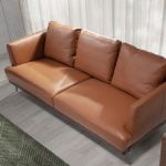 3 seater sofa upholstered in leather with darkened steel legs