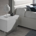 White wooden bedside table and chrome steel