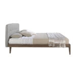 Bed upholstered in fabric with Walnut wood frame