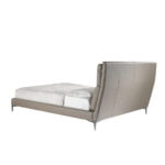 Bed upholstered in leatherette with cushions