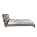 Bed upholstered in leatherette with cushions