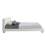 Bed upholstered in leatherette with polished steel legs